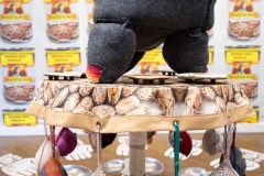 Invisible Woman Syndrome Installation Detail, 2022-26, Mexican serape, Botonaduras, antique white felt, specialty fabric, gray felt, wool, bra insert cups, bras, oil sticks, Mexican pom-pom balls, thread & embroidery floss, 10 feet x 11.5 feet, installed at Martin Museum of Art, Waco, Texas, 2026